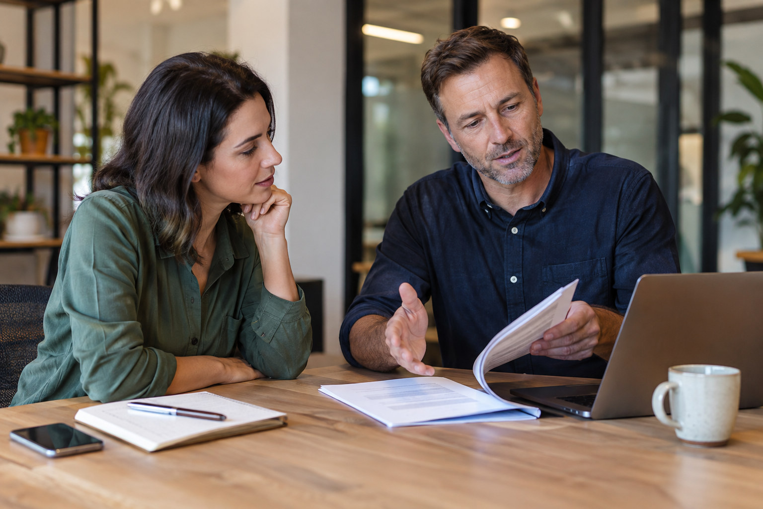 Business owner reviews an SEO service scope with an adviser.